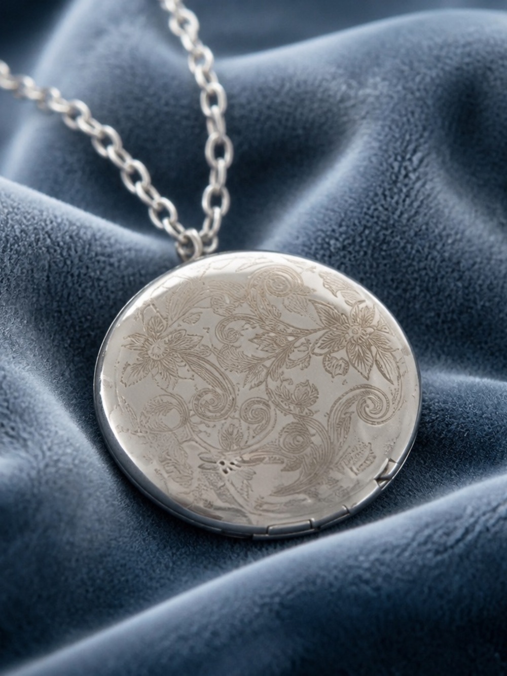 Plunder silver locket features intricate floral engravings necklace